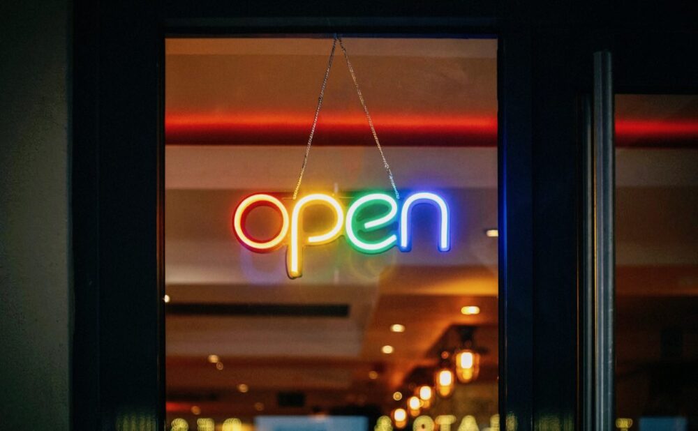Open LED neon sign on clear acrylic backing